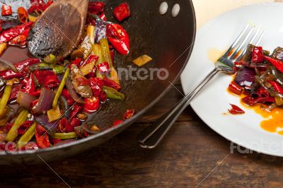 fried chili pepper and vegetable on a wok pan