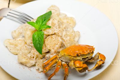 Italian gnocchi with seafood sauce with crab and basil