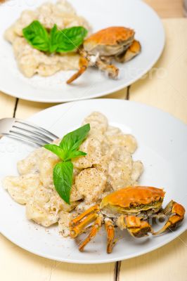 Italian gnocchi with seafood sauce with crab and basil