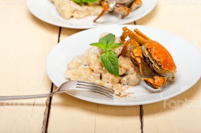 Italian gnocchi with seafood sauce with crab and basil