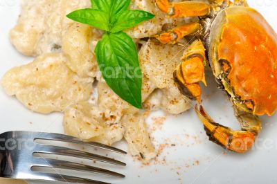 Italian gnocchi with seafood sauce with crab and basil