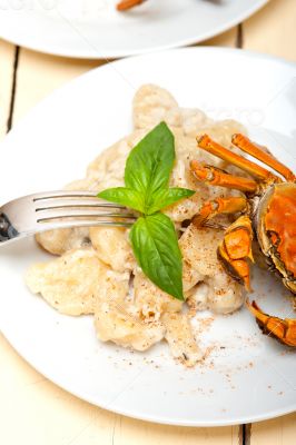 Italian gnocchi with seafood sauce with crab and basil