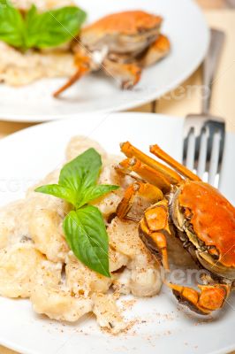 Italian gnocchi with seafood sauce with crab and basil