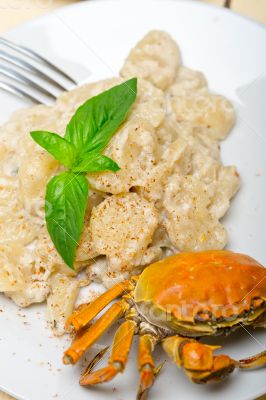 Italian gnocchi with seafood sauce with crab and basil