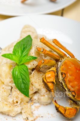 Italian gnocchi with seafood sauce with crab and basil