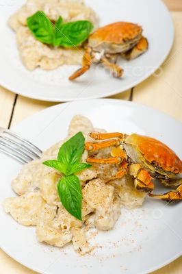 Italian gnocchi with seafood sauce with crab and basil