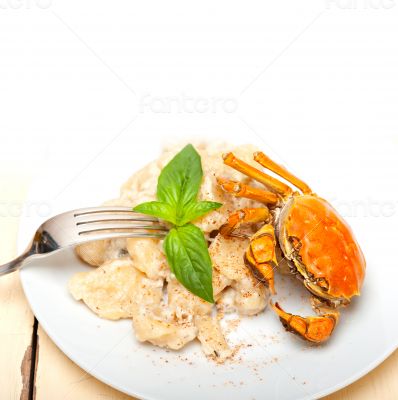 Italian gnocchi with seafood sauce with crab and basil