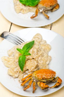 Italian gnocchi with seafood sauce with crab and basil