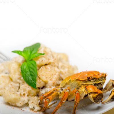 Italian gnocchi with seafood sauce with crab and basil