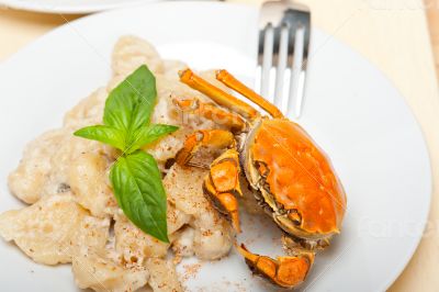 Italian gnocchi with seafood sauce with crab and basil