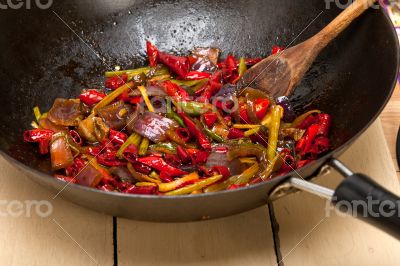 fried chili pepper and vegetable on a wok pan