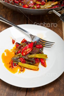 fried chili pepper and vegetable on a wok pan