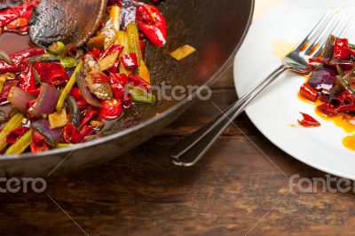 fried chili pepper and vegetable on a wok pan