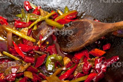 fried chili pepper and vegetable on a wok pan