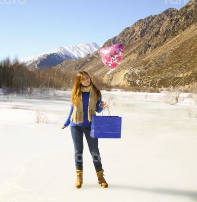 Happy girl with a balloon and a package Happy girl with a balloon and a package