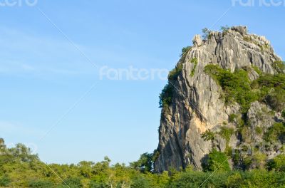 Stone mountains and forests on sky