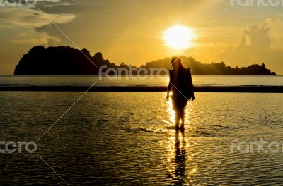 Girls on the beach during sunrise.