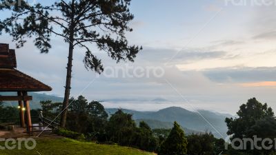 Tourists are standing views of high mountains and haze.