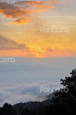 Colorful sunrise above the clouds