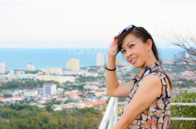 Woman poses on a high point overlooking the city.
