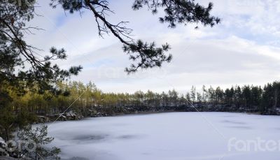 Panorama of an abandoned stone pit in winter 