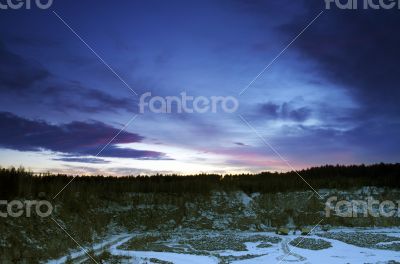 Panorama of an abandoned stone pit in winter 