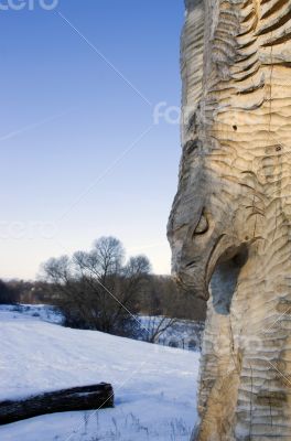 isolated totem wood pole in the blue cloudy background 