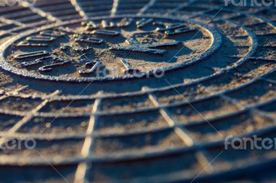 Close-up of the metal manhole cover 