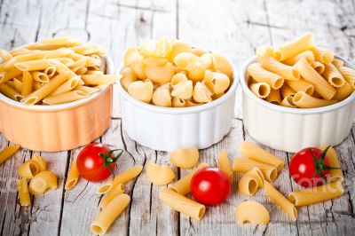 three bowls with uncooked pasta and cherry tomatoes