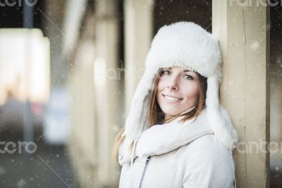 Smiling young woman in blizzard