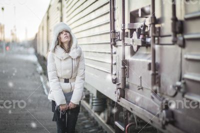 Stylish woman in snowy day on a platform