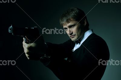 A Secret Agent taking aim with his pistol 