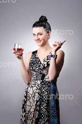 Beautiful smiling girl holding a glass.