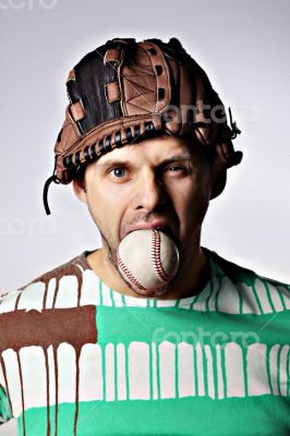 Man with a baseball in mouth 