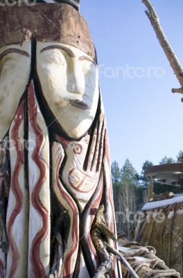 totem wood pole in the blue cloudy background 