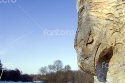 isolated totem wood pole in the blue cloudy background 