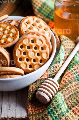 fresh cookies in a bowl, tablecloth and honey 