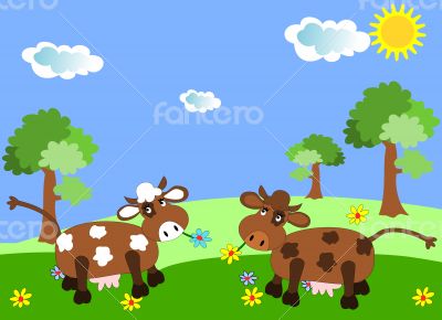 Cows grazing on a green meadow