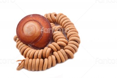 Shell with wood beads on the white background Shell with wood beads on the white background