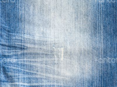 Texture of threadbare denim of indigo color