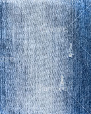 Texture of threadbare denim of indigo color