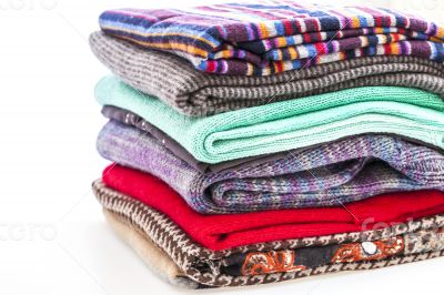 Pile of woolen jumpers of various colors and textures