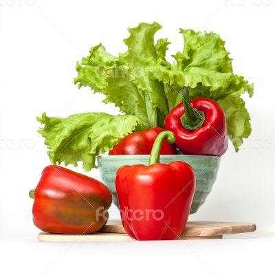 Large red paprika and bunch of fresh salad Large red paprika and bunch of fresh salad