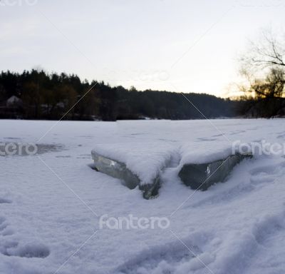 clear river ice in cold winter morning under sunbeams