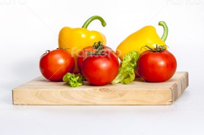 Large paprika of yellow color and red tomatoes
