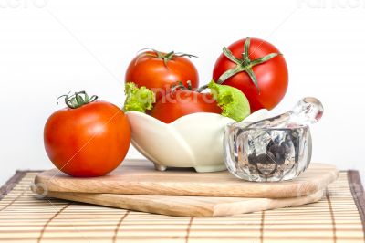 Red juicy tomatoes, lettuce leaves and black pepper Red juicy tomatoes, lettuce leaves and black pepper
