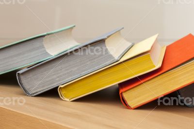 Vintage books in multi-colored covers on a table