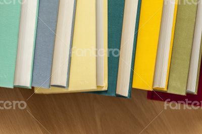 Vintage books in multi-colored covers on a table