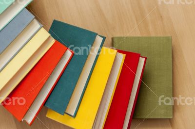 Vintage books in multi-colored covers on a table