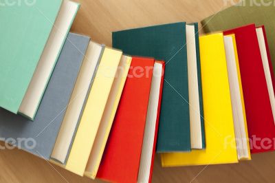 Vintage books in multi-colored covers on a table